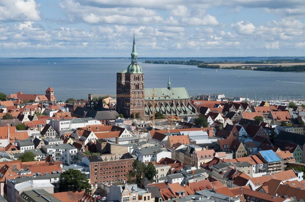 Luftaufnahme von Stralsund, Deutschland mit St.-Nikolai-Kirche und Ostsee im Hintergrund.