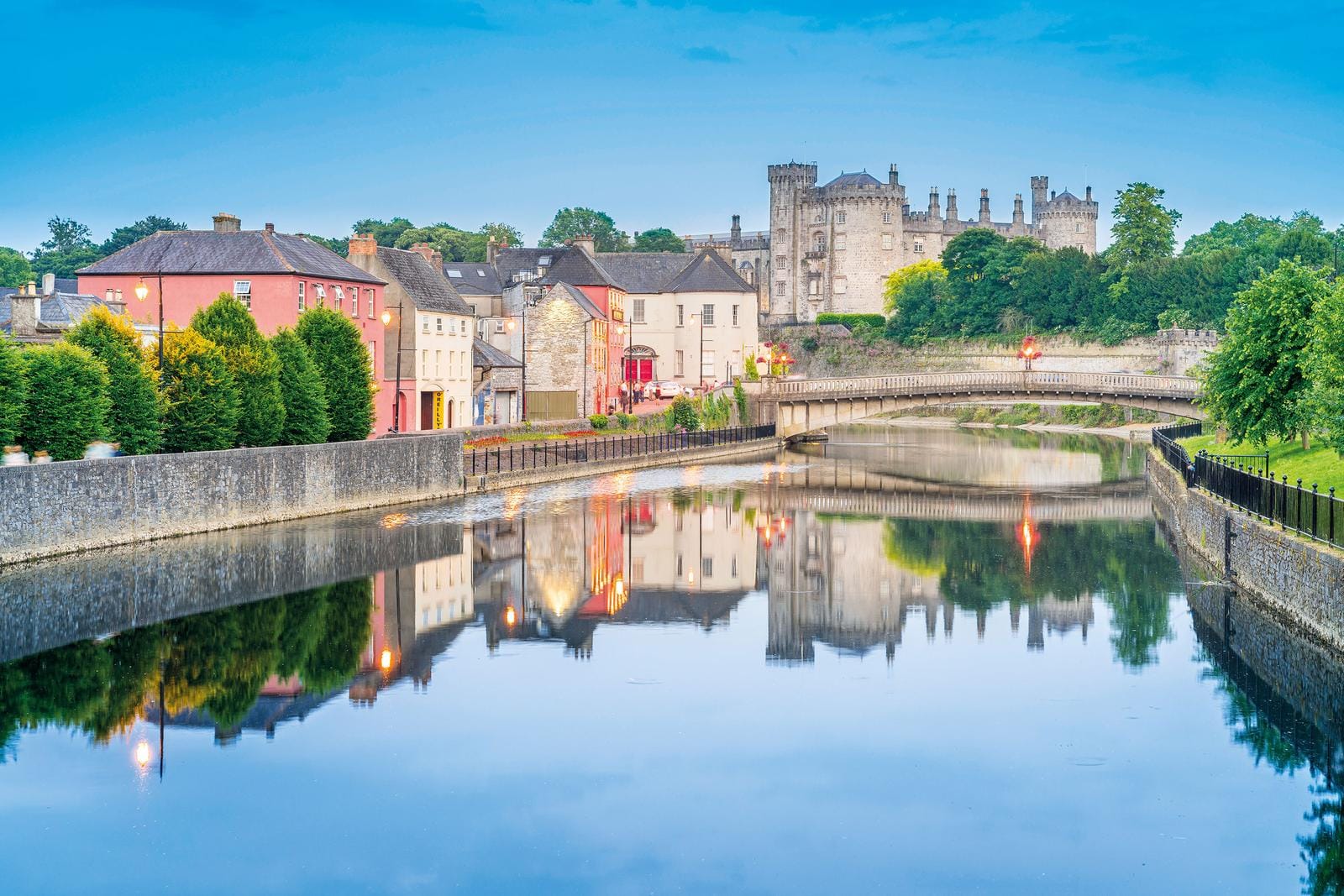 Stadtansicht von Kilkenny, Irland mit Blick auf Fluss und Burg im Abendlicht.